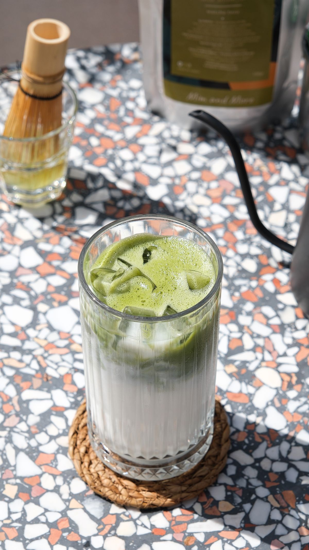 Placeholder photograph of an iced matcha drink on a café table.