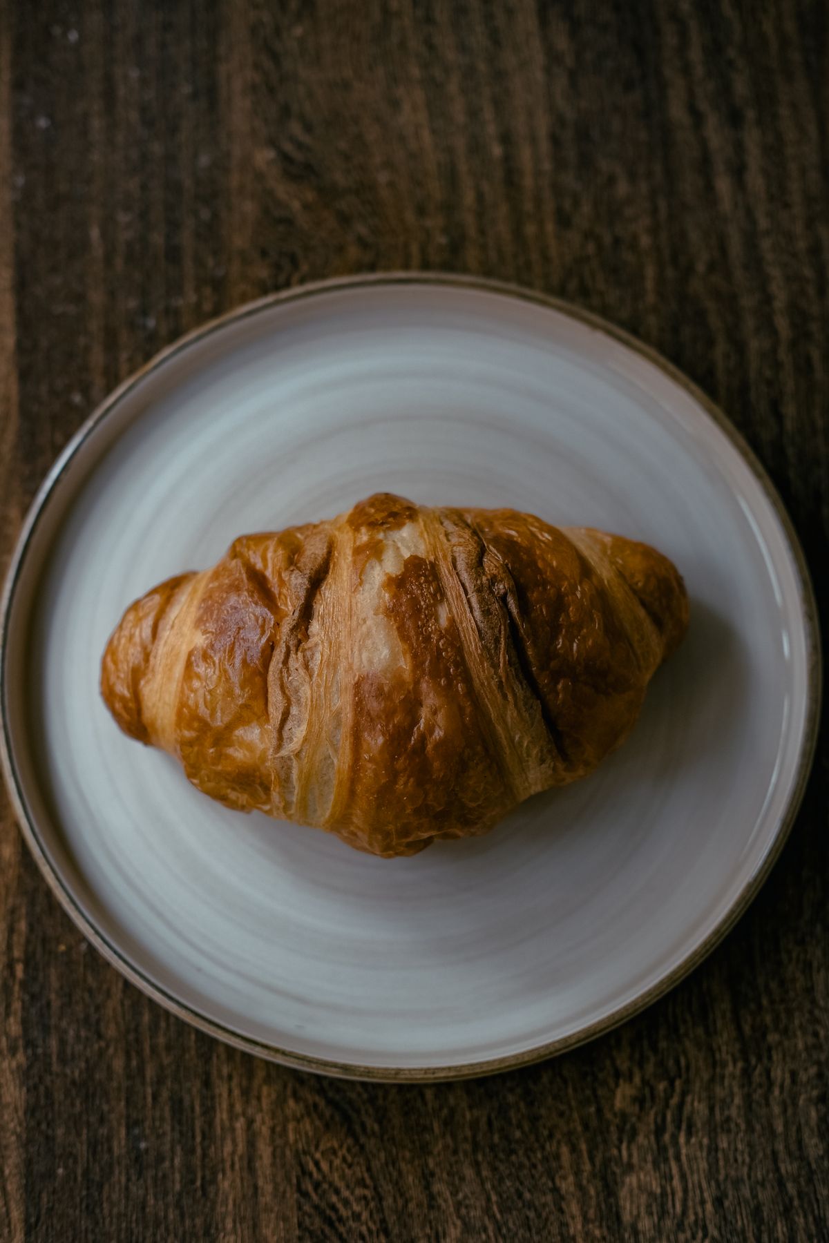 Placeholder photograph of a chocolate croissant on a plate.