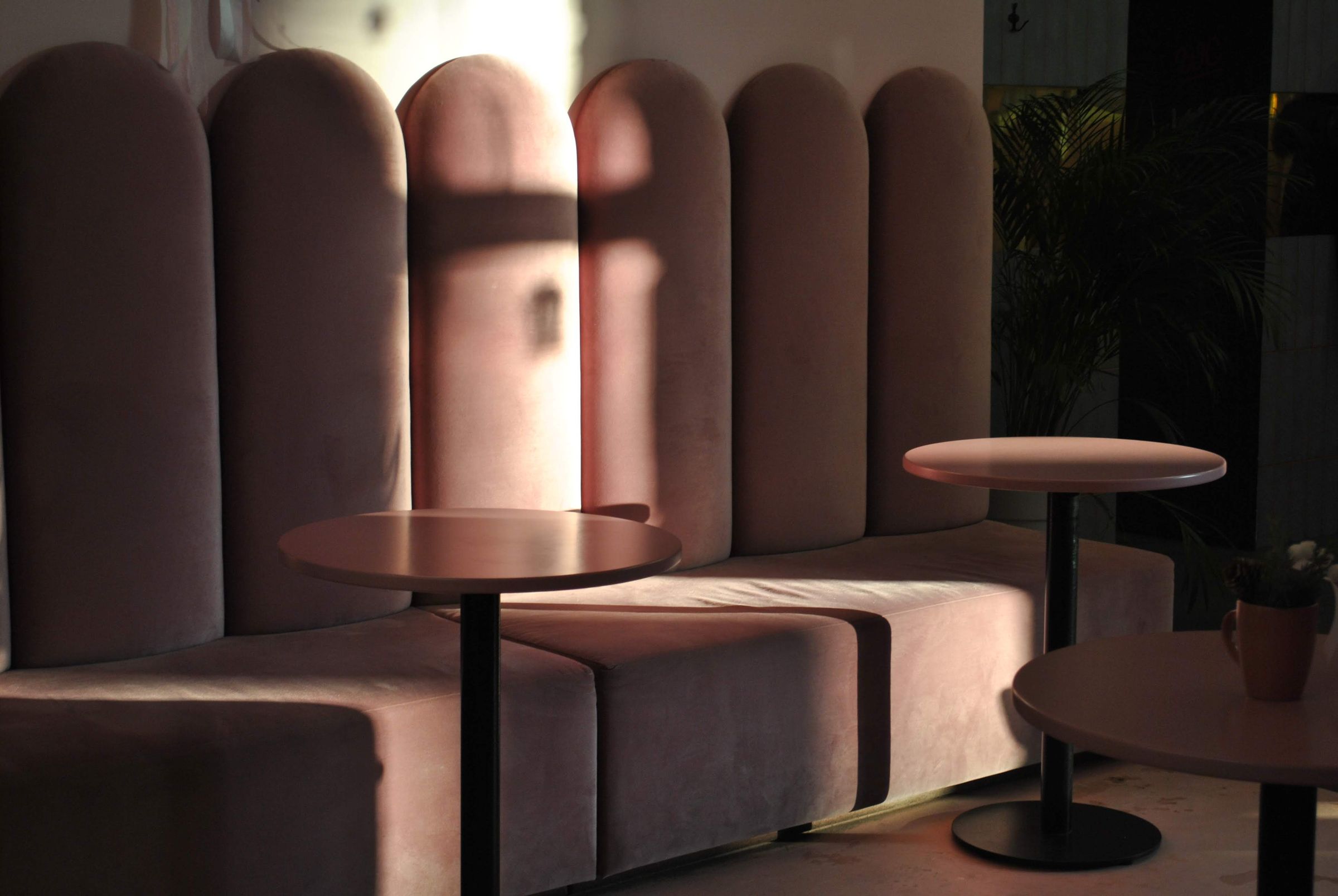 Placeholder photograph of a pink upholstered café booth.